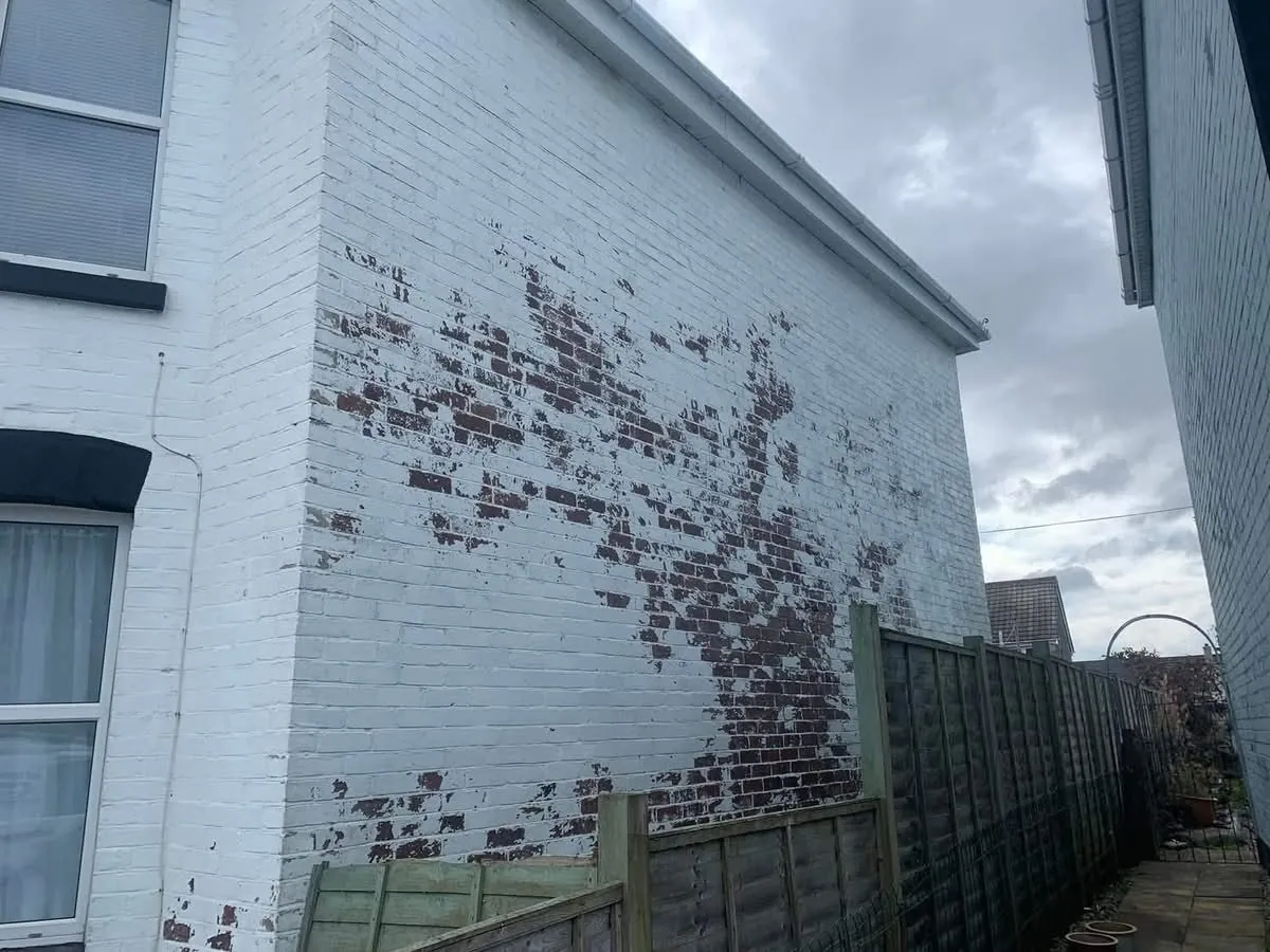 Peeling paint on a brick wall before redecoration in Barnstaple